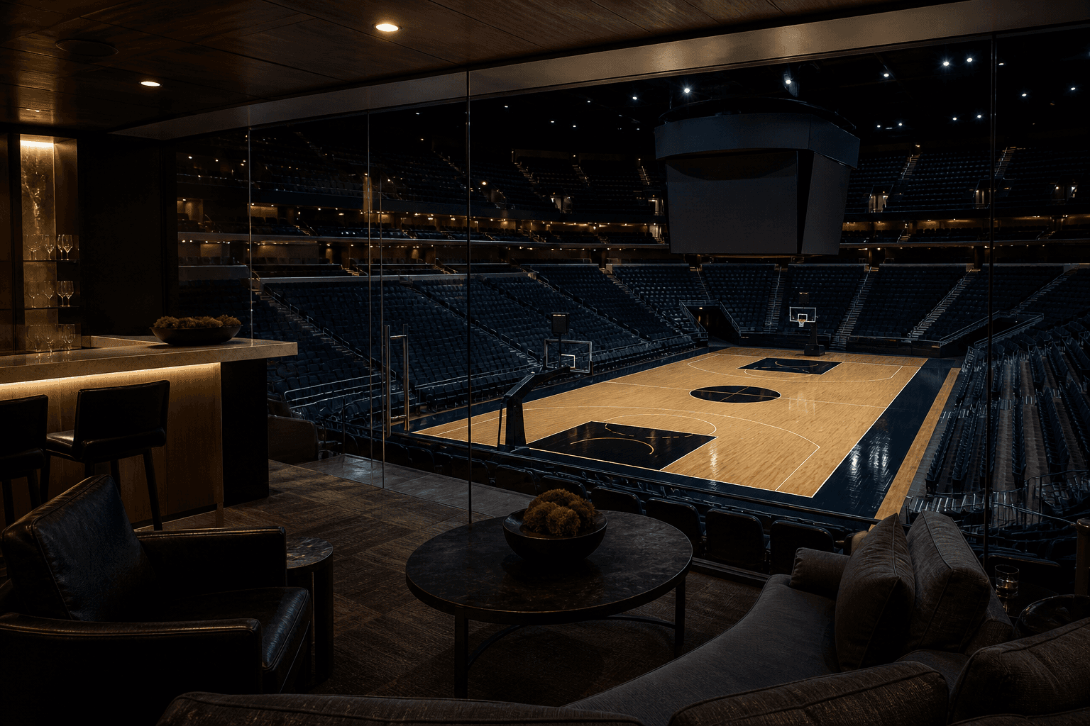A glass VIP arena suite overlooking a basketball court under architectural stadium light.